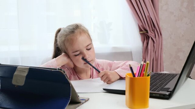 Hybrid learning child studying at home with focus and laptop