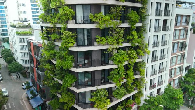 Modern residential building integrating a lush vertical garden across its balconies and facade, bringing urban nature and sustainable architecture to a vibrant city street