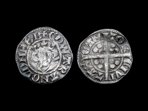 Silver long cross penny English hammered coin of King Edward II Class 11b, 14th century dated around 1310- 1314 minted in Canterbury England, cut out and isolated on black background