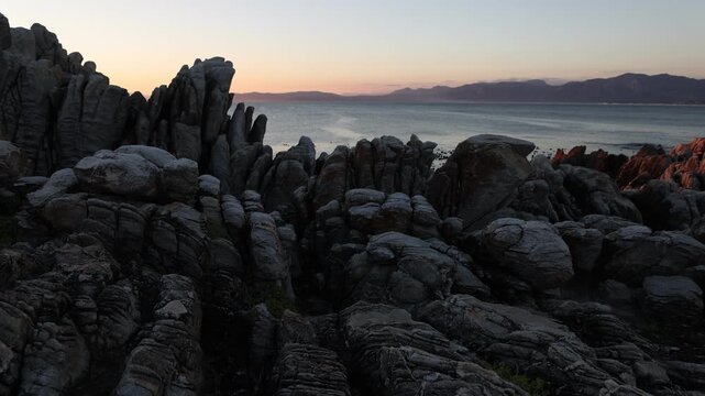rocky coastline of DeKelders, Gansbaai, South Africa at sunset