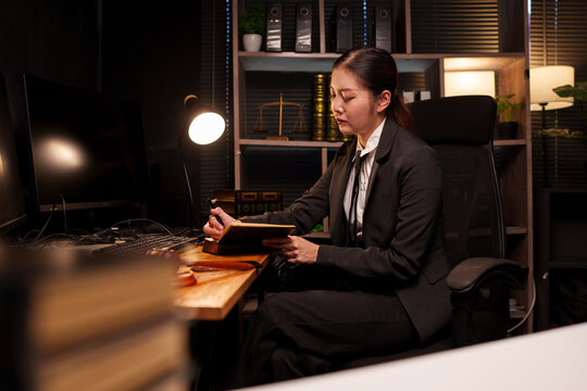 Focused Businesswoman Working Late on Laptop in Dark Office