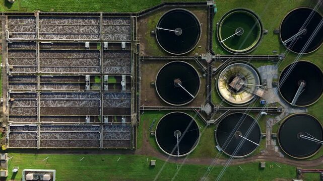 Drone view of industrial water treatment infrastructure and circular clarifying basins.