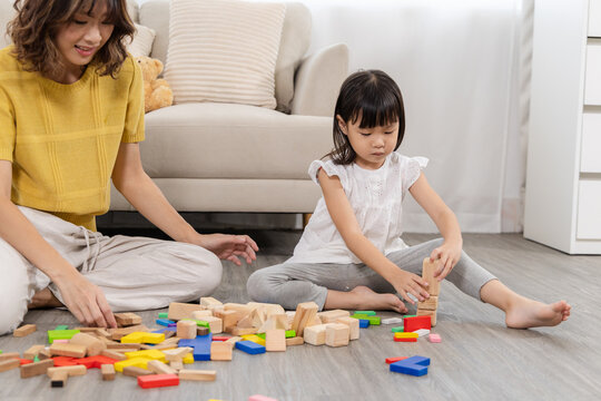 Family bonding relationship, education, homeschool mom and little girl playing wooden toy block, intelligence, problem solving activity, emotional quotient development, happy children play and learn