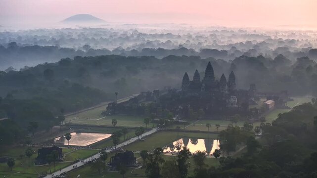 Aerial Drone view of the Majestic Angkor Wat temple complex in cambodia at Sunrise. UNESCO World Heritage Site.
