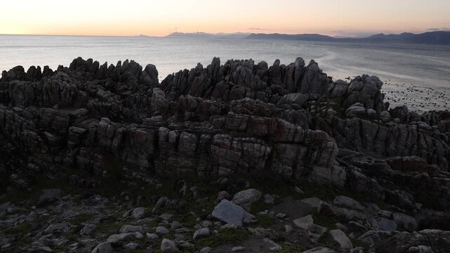 rocky coastline of DeKelders, Gansbaai, South Africa at sunset