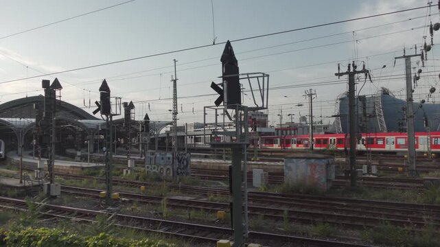 Koln Hauptbahnhof Nordrhein-Westfalen Deutschland. Main station of Cologne in Germany outside view of rails, tracks and roof at sunset in summer located in city center next to Cologne Cathedral. 