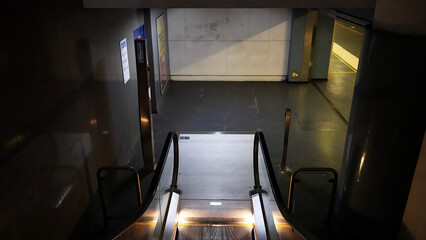 View Down an Empty Escalator in a Dimly Lit Napoli Station © blueringmedia