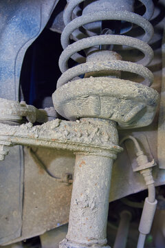 Close-up of dirty car shock absorber,Worn and dirty car chassis parts needing repair or maintenance.
