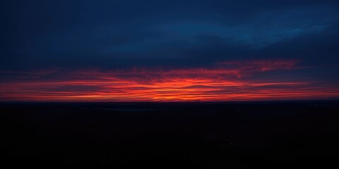 Fototapeta premium Captivating sunset horizon with deep blue background and vibrant orange accents