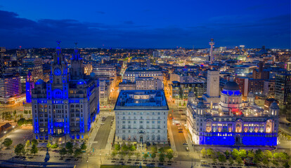 Fototapeta premium Liverpool, England. aerial view of Pier Head with the Three Graces including the Royal Liver Building and Port of Liverpool Building beside the River Mersey waterfront.