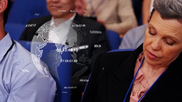 Woman taking notes during tech talk projecting rotating globe time overlays drifting over seats