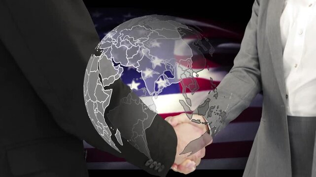 Two partners joining hands at forearms touch holding while globe spinning over US flag sealing deal