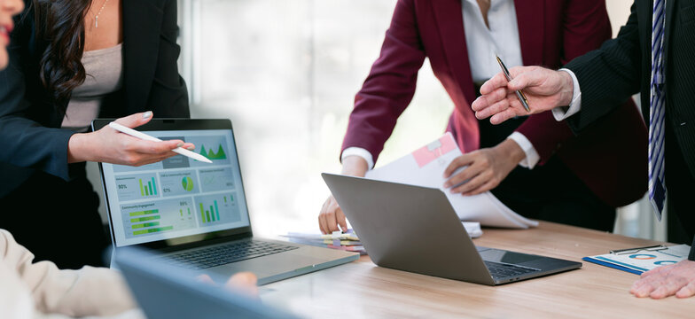 Business Team Analyzing Financial Data on Laptop Screen