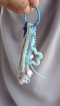 Colorful bag macrame keychain with gray background 