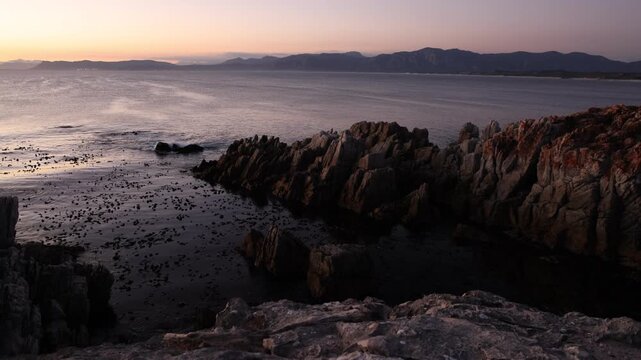 rocky coastline of DeKelders, Gansbaai, South Africa at dusk
