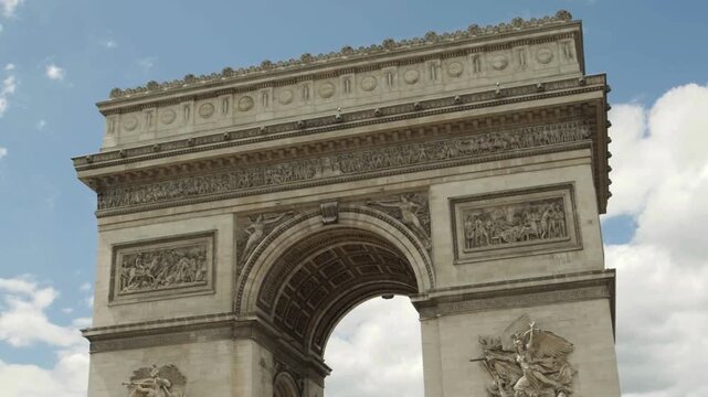 Arc de Triomphe monument with traffic on Champs Elysees in Paris France in 4K