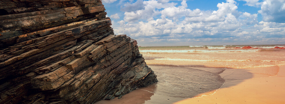 Beach Playa de Augas Santas (Beach of the Holy Waters, As Catedrais beach) during low tide at sunrise. Spain