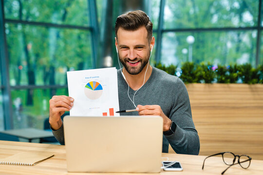 Man, video call laptop in office for paperwork, remote work and graphs for report. Freelancer, business documents and tech for project management, finance agency, giving consultation, conference app
