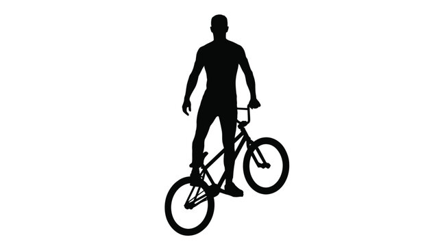 Silhouette of a young man performing a stylish trick on his bmx bicycle in this photo