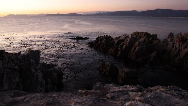 rocky coastline of DeKelders, Gansbaai, South Africa at dusk