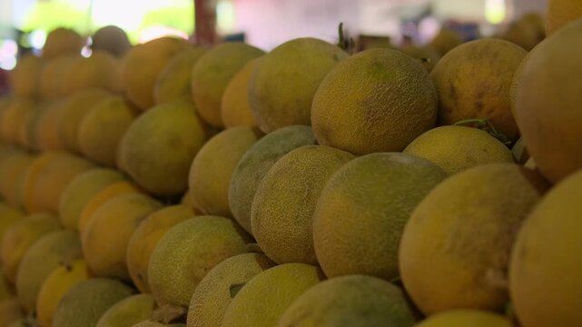 Local market culture authentic street market life with fresh melons on produce stall, abundance of fruit at busy bazaar, healthy organic food concept