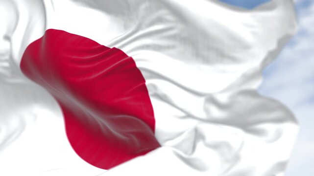 Japan national flag waving in the wind on a clear day. Red disc on a white field. Seamless 3d render animation. Slow motion loop. Selective focus