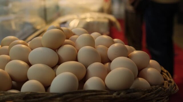 Local market culture authentic street market life with fresh eggs in basket, hand selecting egg at produce stall, organic food shopping concept