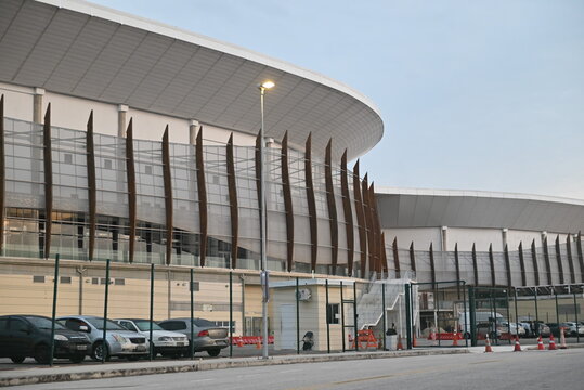 RIO DE JANEIRO, BRAZIL - MAIO 17: The modern architectural facade of the Arena MRV stadium stands behind a row of parked cars and a