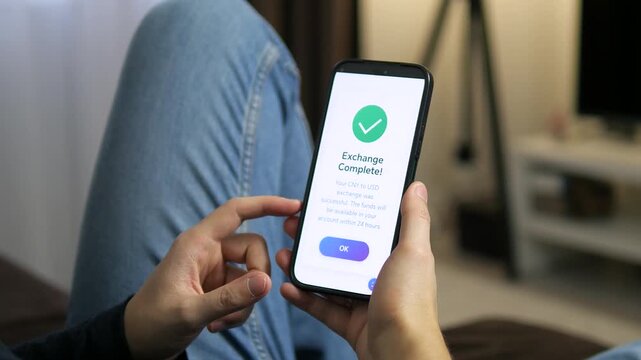 Hands holding a phone showing a currency exchange receipt. The message confirms a successful transfer with a clean, minimal design. Great for showcasing trust, cross-border payments, and modern