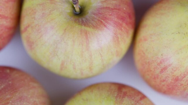 Apple arrangement display. Fresh apples arranged in grid. Closeup of apples in grid pattern. Macro shot showing apple skin texture and farm fresh qualities for branding