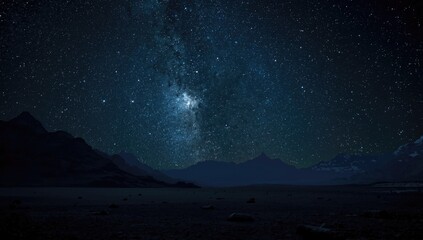 Fototapeta premium Alien planet surface with mountain silhouettes and star filled dark cosmos