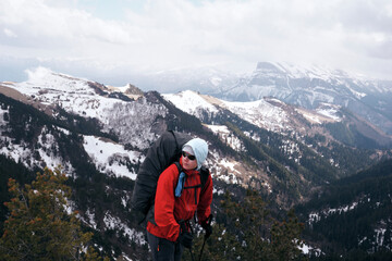 Fototapeta premium man with a backpack in the mountains. Trekking in the mountains, backpacker traveler.