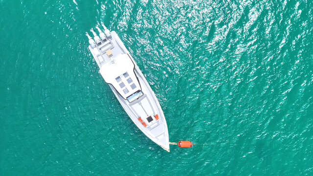 Aerial Top Down View of White Speedboat Anchored in Turquoise Water