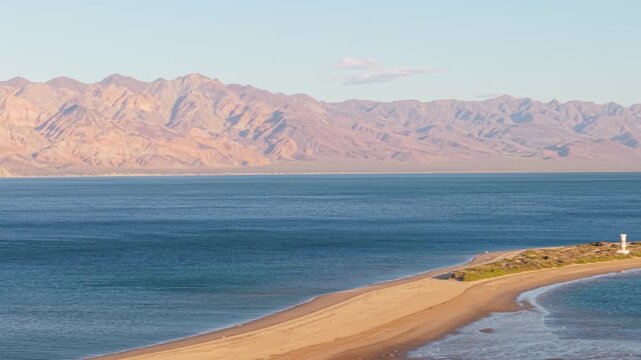 Aerial shots show Bahia de Los Angeles in Baja California during late afternoon with clear skies and calm waters in the distance.