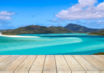Fototapeta premium Wooden table top on the beach or sea.Party on the beach sunshine time concept.For montage product display or design key visual layout.View of copy space.