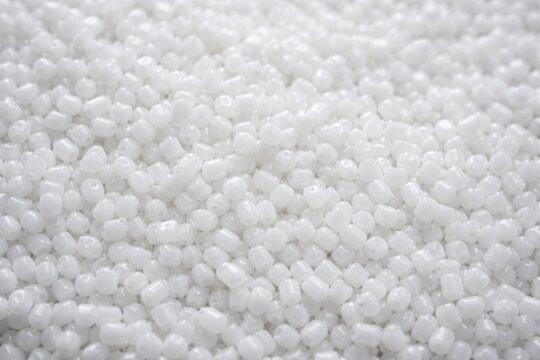 Small white polypropylene granules texture background