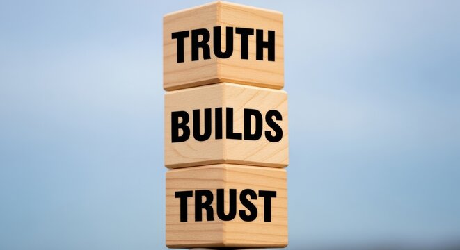 Wooden Blocks Stacked Vertically Spell Out 'Truth Builds Trust' Against a Soft Blue Sky