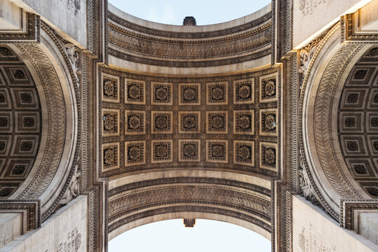 View of the intricate coffered ceiling and ornate stone carvings of the Arc de Triomphe, Paris, Ile-de-France, France.