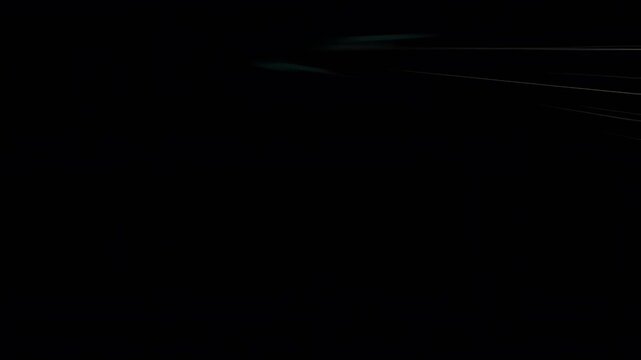 Abstract black background with subtle light streaks and motion blur