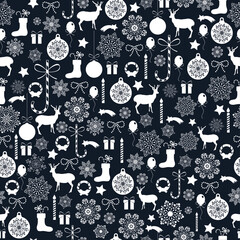 Seamless Christmas pattern with white reindeer and snowflakes on dark blue background © Kyzee