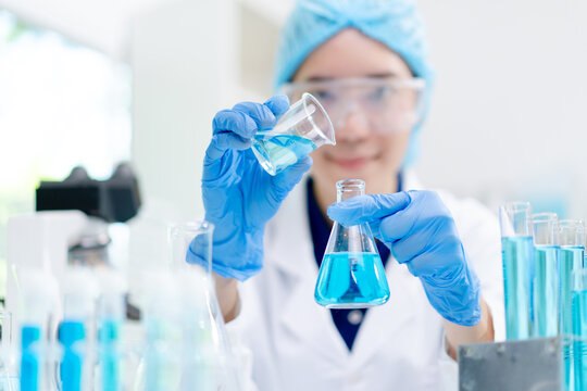 hand of scientist hold test tube with liquid chemical water to recheck experiment result in laboratory, doctor with blue glove research and analyze biochemistry for healthcare and medical innovation