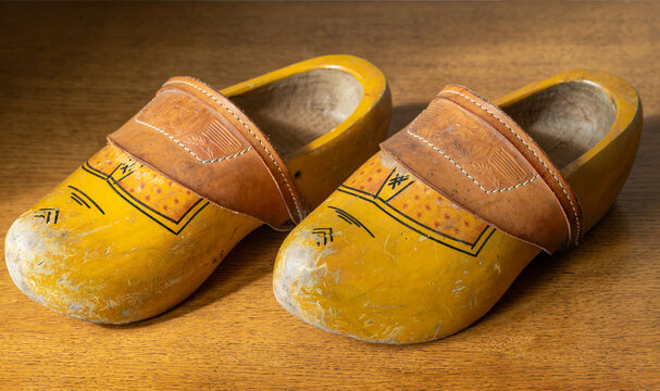Vintage Dutch Wooden Clogs (Klompen) on Rustic Wooden Surface, Cultural Symbol Of The Netherlands