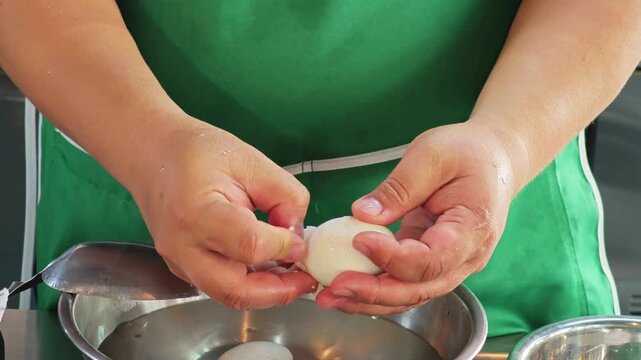 Process of peeling boiled eggshell, professional kitchen technique.