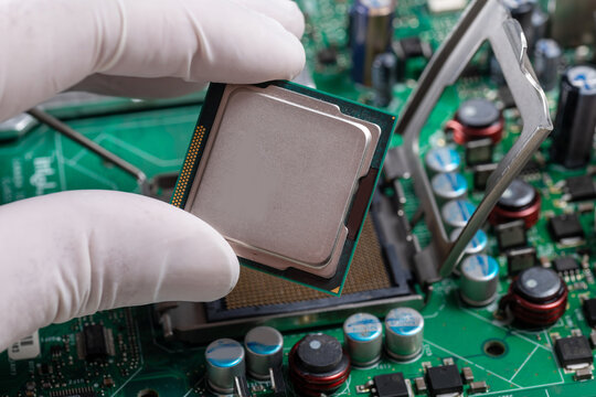 Modern Computer Technician Handling CPU Chip Installation On Desktop PC Motherboard Close Up