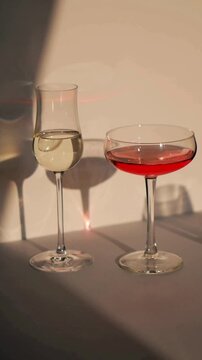 Hand Taking Wine Glass from Table with Three Elegant Glasses in Luxury Dinner Setting