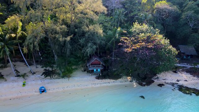 Experience the peaceful charm of Koh Wai Island in Thailand, where soft sands meet crystal clear waters. Relax in a cozy beach hut surrounded by lush greenery and natural beauty.