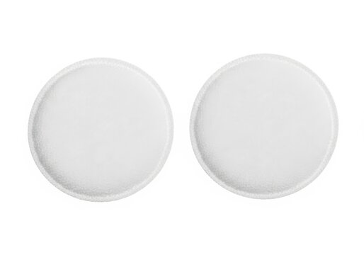 Two round, textured white pills displayed side by side isolated on white background