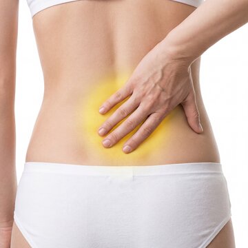 A woman's hand touching her lower back indicating pain with a prominent yellow highlight