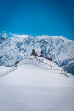 Gergeti Church Surrounded by Winter Mountains