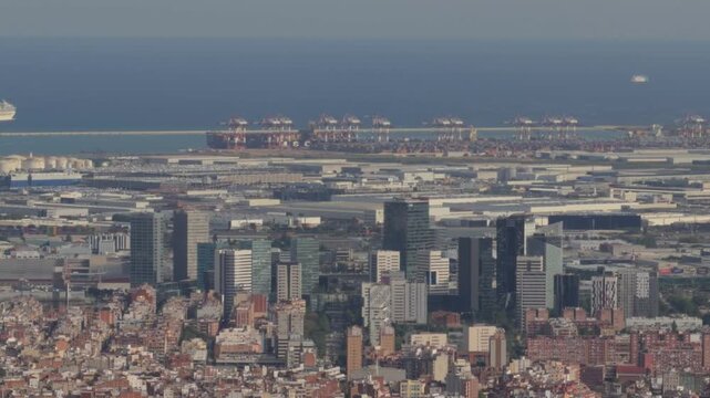 Expansive aerial view of barcelona's modern skyline, showcasing the bustling industrial port and serene mediterranean sea under a clear blue sky on a sunny day